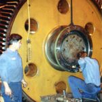 Journal bearings are being removed from a large steel mill gear box prior to doing shaft repair work. 